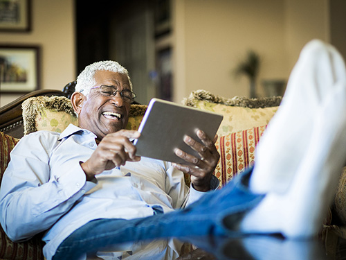 Man enjoying free time watching entertainment on ipad>